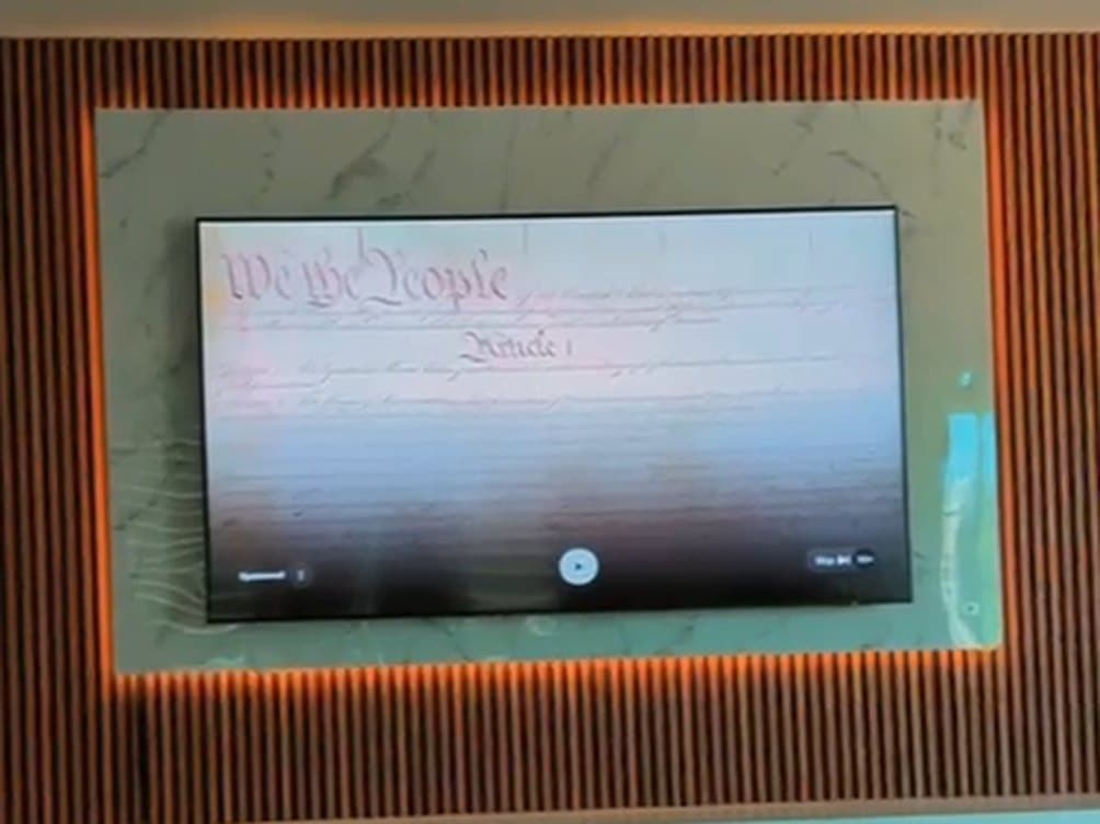 Finished: backlit marble TV wall with slatted wood surround and warm LED glow