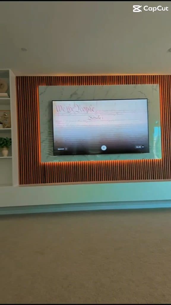 Finished custom TV wall with warm LED backlighting